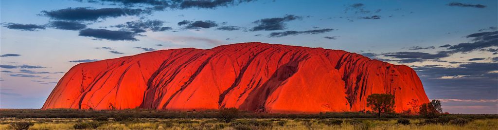 Red color of Uluru is due to oxidation or the rusting of the iron-bearing minerals within the rock.